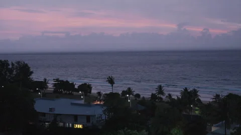 Resort Buildings and Trees by Ocean Under Pink Twilight Sky 스톡 동영상 337534074