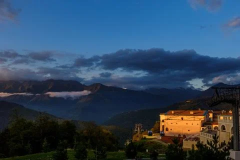 The resort complex at sunset on a background of mountains. Stock Photos