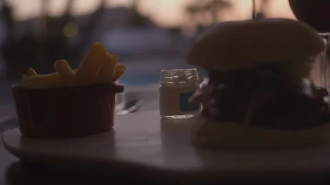 Resort Package 167 |hamburger dinner table woman dipping fries in mayonnaise Stock Footage 118653750