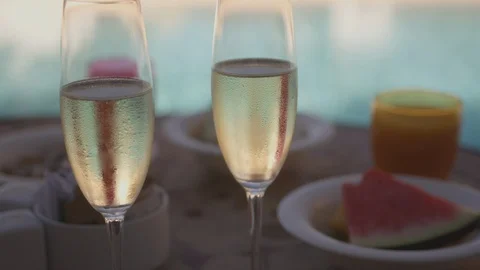 Resort Package 179 | dynamic shot breakfast fruits at pool champagne glasses Stock Footage 118654266