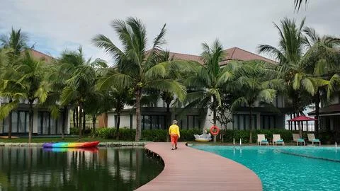 Resort with Pond and Pool Separated by Walkway Фото