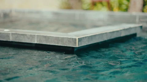 Resort Pool Edge With Calm Blue Water and Infinity-Style Tile Detail at Sunset Stock Footage 333270189