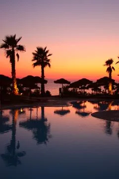 Resort pool at sunset Stock Photos