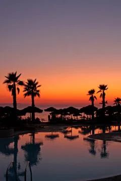 Resort pool at sunset Stock Photos