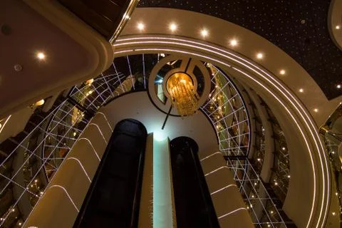 Respectable and shining interior design with elevators in luxurious cruise sh Stock Photos