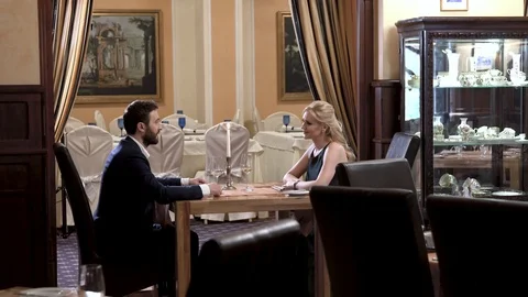 Respectable dressed, confident young man with a beard touches woman hand Stock Footage 89045144