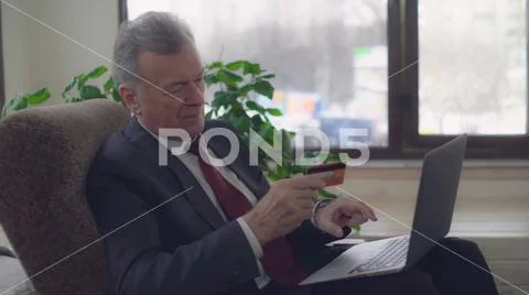Respectable gentleman use computer for online banking Stock Photos