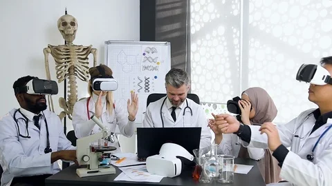 Respectable good-looking gray-haired doctor-mentor managing the work of his Stock Footage 122585385