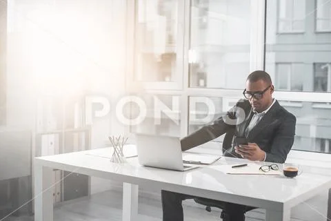 Respectable man typing message in mobile Stock Photos