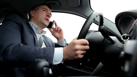 Respectable, responsible man driving car and speaking on mobile phone Stock Footage 81305125