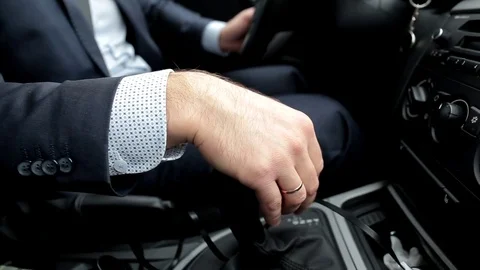 Respectable, responsible man driving car. The man holds the lever. Close up Stock-Footage 81305827