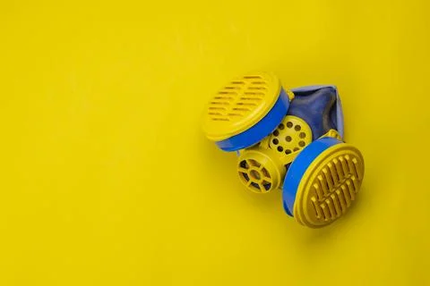 Respirator type half mask with replaceable filters on yellow background. Stock Photos