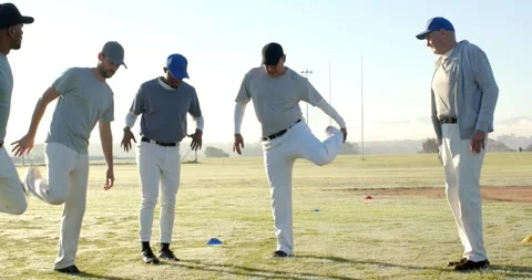 Responding to coach gesture, Diverse baseball team performing warm-up drill on Stock Footage 340968481