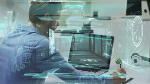 Responding to HUD appearing, blue-shirted man leaning at desk, using laptop and Stock Footage 332900414