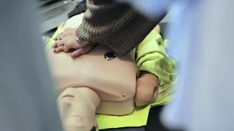 Responding to a medical emergency: hands performing CPR chest compressions on a 스톡 동영상 323752677