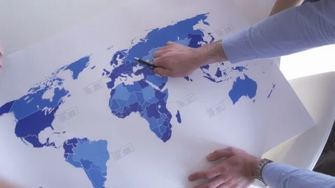 Responsible young adults analyzing the world map Stock Footage 73864752