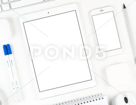 Responsive design: Keyboard, tablet and smartphone on white table Stock Photos