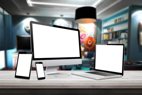 Responsive display devices on table in living room. Isolated white screen fo Foto stock