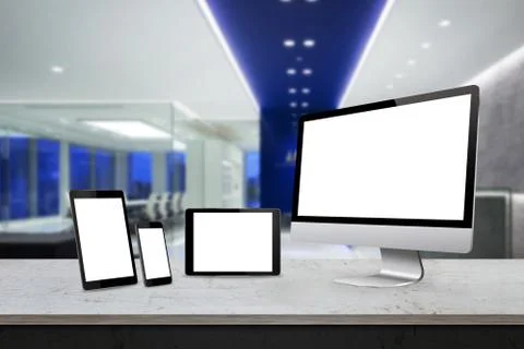 Responsive display devices on table in office. Isolated white screen for mockup  Stock Photos