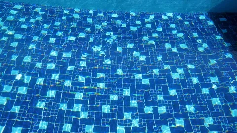 Rest. At home. Bald middle-aged man swimming in the pool with blue bottom. Stock Footage 129503633