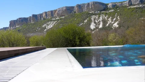 Rest. At home. Bald middle-aged man swimming in the pool with blue bottom. Stock Footage 129555481