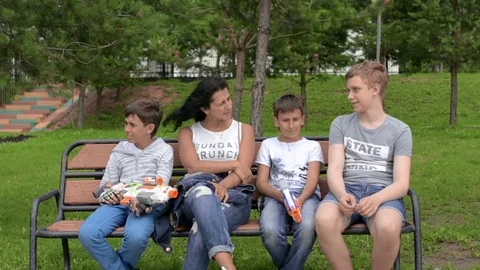 Rest in the park on a bench. Around beautiful green grass. Video stock 78214105
