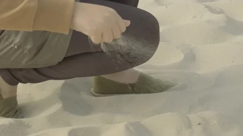 Rest on the sea.Sand slips through your fingers.slow motion. Stock Footage 235890669