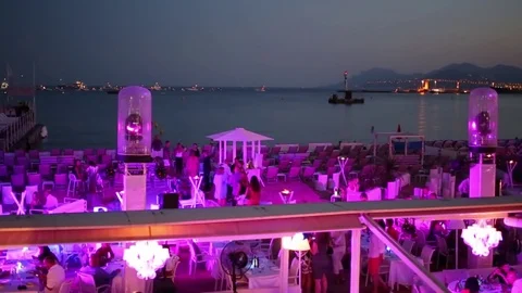 Restaurant and the rows of seats on the seafront in the evening Stock Footage 71105149