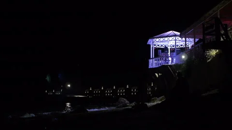 Restaurant at beach at night when moon path lighting on waves 库存影片 68345457