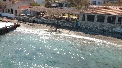 A restaurant on a beach of the sea with waves Stock Footage 105752250