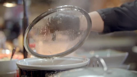 Restaurant chef checks on pots Stock Footage 99400206