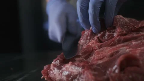 Restaurant chef cut raw meat; hands cutting, slicing delicate beef 4K Stock Footage 170832290
