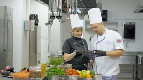 Restaurant chef makes a verification in kitchen. Interacting to head chef in Stock Footage 145522852