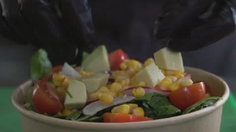 Restaurant chef making salad adding fresh vegetables, close-up on hands Stock Footage 246237682