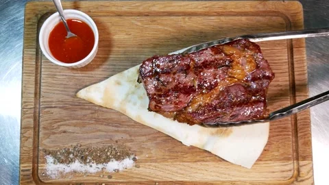 Restaurant chef slicing medium rare beef steak. Video stock 131718448