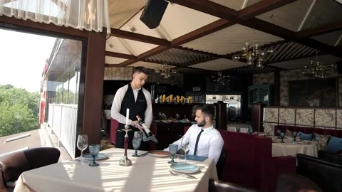 In The Restaurant, The Client Accepts The Order Of A Stylish Man In An Elite Stock Footage 172354425