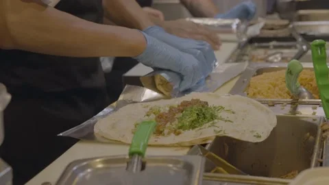 Restaurant cook assembles burrito Stock Footage 217815569