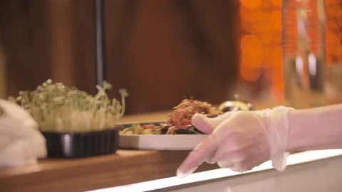 Restaurant cooking - the chef serves the dish in the distribution area and beats Stock Footage 171870849