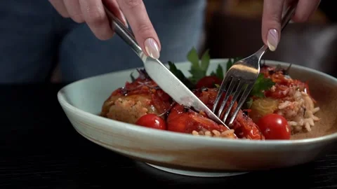 Restaurant customer trying dish with fork and knife. Close-up woman hands. Stock Footage 168839983