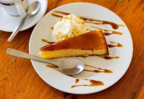 Restaurant dessert on plate - triangular piece of catalan cream pie with caramel Stock Photos