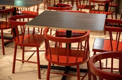 Restaurant dining seating area with empty red tables and chairs Stock Photos
