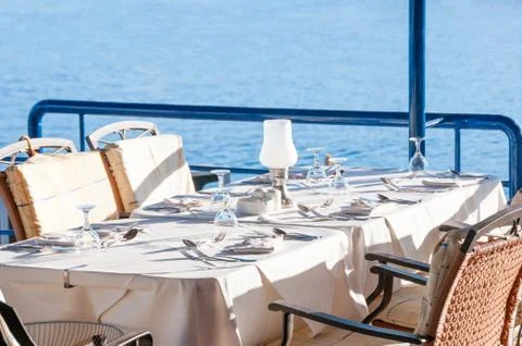 Restaurant Dining Table with an Ocean View Stock Photos