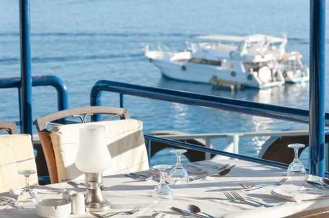 Restaurant Dining Table with a View of Yachts in the Bay Stock Photos