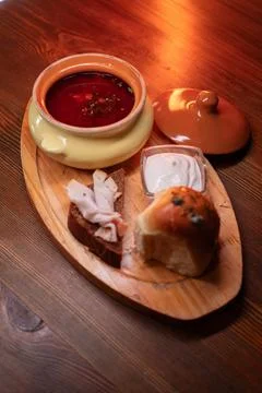 Restaurant dish borscht, delicious bread with bacon, sour cream, bun. A Stock Photos