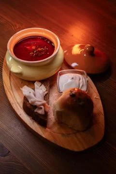 Restaurant dish borscht, delicious bread with bacon, sour cream, bun. A Stock Photos