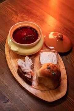 Restaurant dish borscht, delicious bread with bacon, sour cream, bun. A Stock Photos
