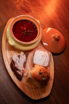 Restaurant dish borscht, delicious bread with bacon, sour cream, bun. A Stock Photos