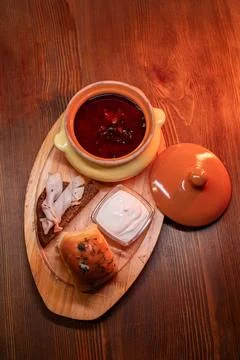 Restaurant dish borscht, delicious bread with bacon, sour cream, bun. A Stock Photos