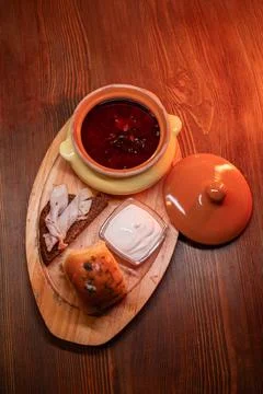 Restaurant dish borscht, delicious bread with bacon, sour cream, bun. A Stock-Fotos