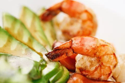 Restaurant dish. fried prawns with avocado and cherry. photo in the shine Stock Photos